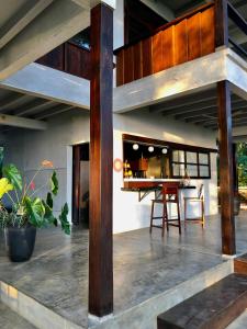 an open kitchen and dining area of a house with wooden beams at The Hill Panama in Cambutal