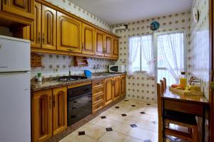 cocina con armarios de madera y encimera en Amplio piso en zona céntrica de Baena, en Baena