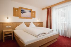 Posteľ alebo postele v izbe v ubytovaní Apart Tyrol inkl der SUPER SOMMER CARD im SOMMER 2025