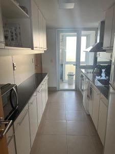 Kuchyň nebo kuchyňský kout v ubytování Edificio Calypso - Primera línea al Mar