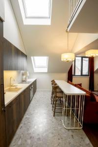 a kitchen with a table and chairs in a room at Loft 27 in Kaunas