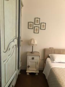 a bedroom with a bed and a table with a lamp at Colle House in Rivisondoli