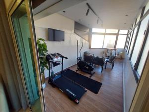 Zimmer mit einem Fitnessraum mit Laufband und einem Wohnzimmer in der Unterkunft modern apartment opposite to HASSAN2 MOSQUE with side SEA view with sports machines with free underground GARAGE prohibited for unmarried couples of Arab origin space of 85m apartment too QUIET in Casablanca