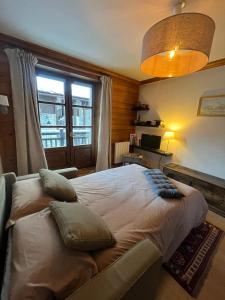 um quarto com uma cama grande e uma janela em Adorable 30m2 Coeur de Val 1 chambre 2 lits em Val dʼIsère