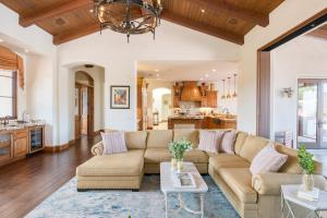 a living room with a couch and a table at Ascension by AvantStay Pool Pickleball Views in Rancho Santa Fe
