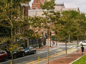 a city street with cars parked on the side of the road at Sonder 907 Main in Cambridge