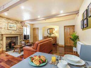 a living room with a table with a plate of food at 1 Bed in Crieff 87497 in Crieff