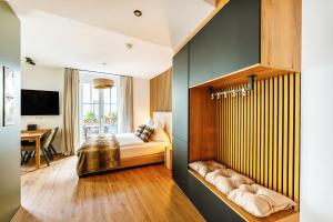 a bedroom with a bed and a desk at Black Forest Luxury Apartment Waldglück mit Sauna in Königsfeld im Schwarzwald