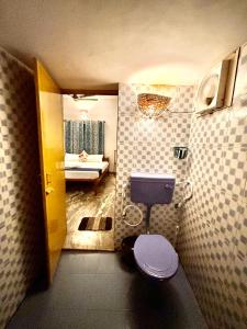 a bathroom with a toilet in a room at The Barefoot Varkala in Varkala