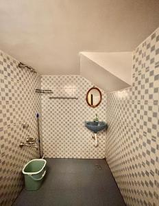 a small bathroom with a sink and a shower at The Barefoot Varkala in Varkala