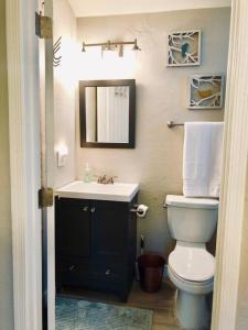 a bathroom with a white toilet and a sink at Sunny Guest Suite with large backyard - Pets Welcome in Phoenix