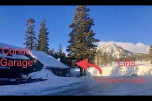 a snow covered road with a building and a red arrow at St Anton Condos #77 condo in Mammoth Lakes