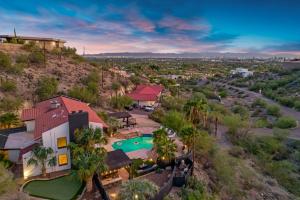 an aerial view of a house with a swimming pool at Desert Lagoon by AvantStay Luxury Phoenix Home w Entertainer’s Backyard in Scottsdale