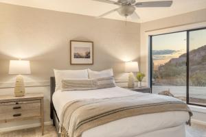 a bedroom with a bed and a large window at Desert Lagoon by AvantStay Luxury Phoenix Home w Entertainer’s Backyard in Scottsdale