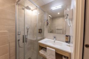 a bathroom with a shower and a sink at Hotel Saint Augustin in Strasbourg