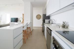 a kitchen with white counters and white appliances at Amchit Bay Beach Residences 2BR w Private Pool in Jbeil