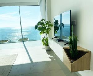 a living room with a view of the ocean at Amchit Bay Beach Residences 3BR Rooftop w Jacuzzi in Jbeil