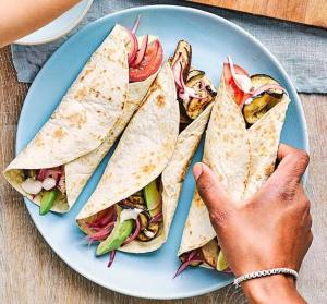 a person is reaching for a plate of food at Space Hostel Amsterdam Zaandam in Zaandam