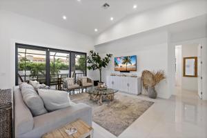 a living room with a couch and a table at Pet-friendly home near shops with pool and spa in Marco Island