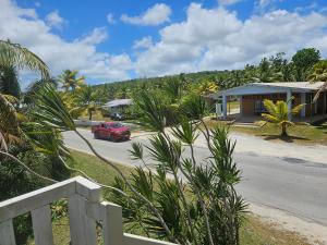 a red car parked in front of a house at Heleni Jessop's Fatahega in Alofi