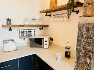 a kitchen with a microwave on a counter at Lancaster Place 18 in Carnforth