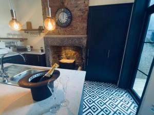 a counter with a wine glass and a fireplace at Lancaster Place 18 in Carnforth