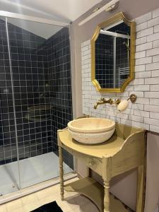 a bathroom with a sink and a shower at Chez Montgaud in Verdun