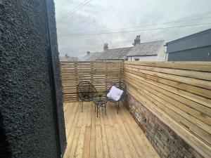 a patio with two chairs and a table on a fence at Lancaster Place 20 in Carnforth