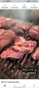a bunch of meat cooking on a grill at finca casita el mirador in Medellín
