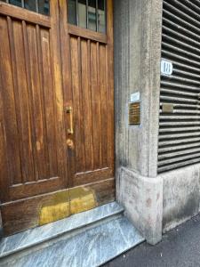 a wooden door on the side of a building at [Stazione SMN]Art House Florence in Florence