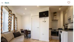 a living room with a couch and a kitchen at Captivating 1-Bed Apartment in Southampton in Southampton