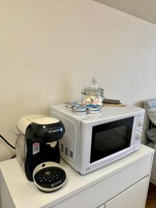 a microwave sitting on top of a counter with a blender at Speir dorcha cabin in Omagh