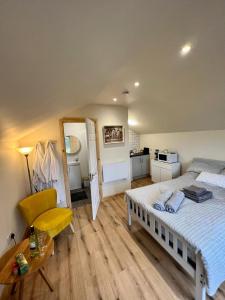 a bedroom with a bed and a table and a chair at Speir dorcha cabin in Omagh