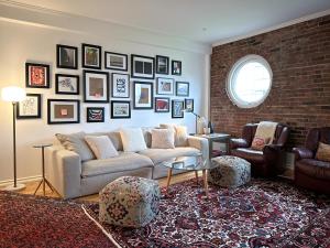 a living room with a couch and a brick wall at Historic Townhouse in Kitsilano in Vancouver