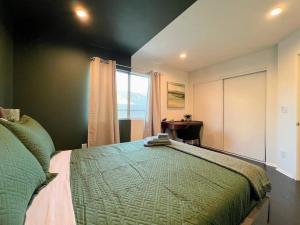 a bedroom with a bed and a desk and a window at 2BR Suite in the Heart of Hollywood -BR5 in Los Angeles