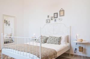 Ένα ή περισσότερα κρεβάτια σε δωμάτιο στο B&B Novecento Siciliano