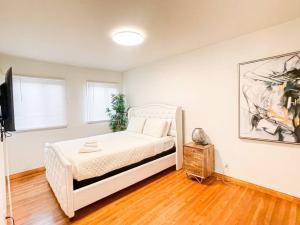 a bedroom with a bed and a television in it at Family-Friendly 2BR in Quiet Area -AM1 in Los Angeles
