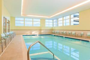 a large swimming pool with chairs and tables at Residence Inn by Marriott Nashville Vanderbilt/West End in Nashville