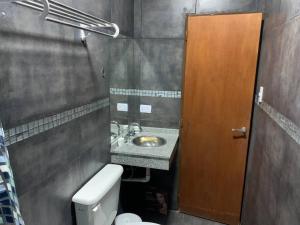 a small bathroom with a sink and a toilet at Rioja Suites - Departamento Céntrico. in La Rioja