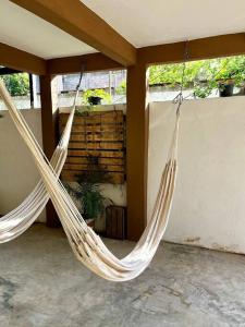 two white hammocks hanging from a porch at Casa Guiba 3 Puerto Escondido in Puerto Escondido