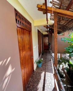 a hallway of a house with a wooden door at Casa Guiba 3 Puerto Escondido in Puerto Escondido