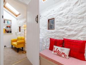 Great Longstone的住宿－2 Bed in Ashford-In-The-Water 85314，客房配有红色枕头和黄色椅子。