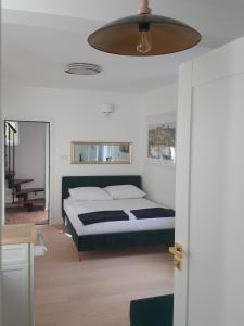 a bedroom with a bed and a ceiling at APARTAMENTY ZIELONY KAMELEON in Busko-Zdrój