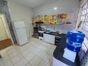 una cocina con una jarra de agua azul en un mostrador en Quartos centro de londrina Ar condicionado, en Londrina