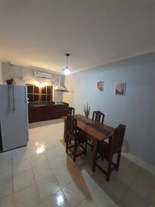 a kitchen with a table and chairs and a refrigerator at Departamento del Centro in Chilecito +7 photos