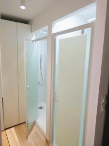 a bathroom with a shower and a glass door at Apartamento Maribel a pie de pista in Sierra Nevada