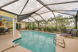 a swimming pool with a glassconservatory with at Waterfront North Fort Myers Home with Private Pool! in North Fort Myers