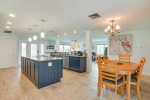 a kitchen and dining room with a table and chairs at Waterfront North Fort Myers Home with Private Pool! in North Fort Myers