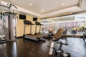 a gym with cardio equipment and a large window at Brooks Beach Vacations 4 star Wyndham Resort 2003 Waikiki in Honolulu