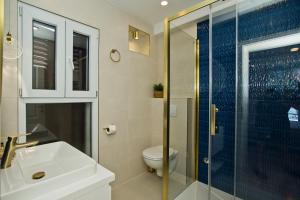 a bathroom with a toilet and a sink and a shower at Villa Milton Luxe Hvar in Hvar